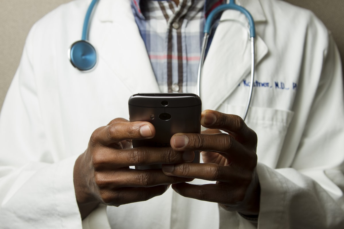 Healthcare professional reviewing patient records on a tablet